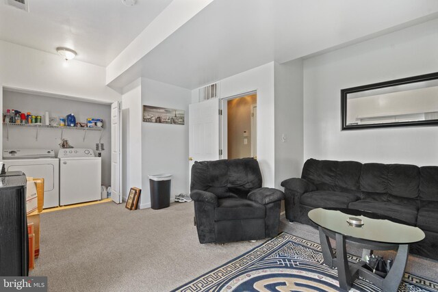 carpeted living room featuring washer and clothes dryer