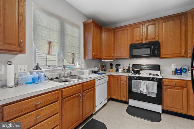 kitchen featuring sink and white appliances