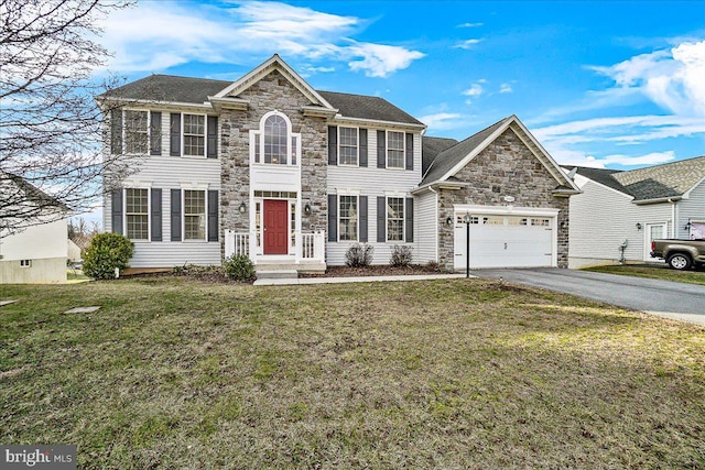 view of front of home with a front yard and a garage