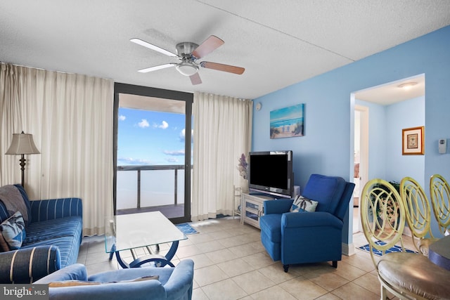 tiled living room featuring ceiling fan and a textured ceiling