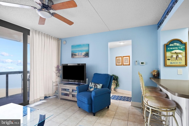 tiled living room featuring a textured ceiling and ceiling fan