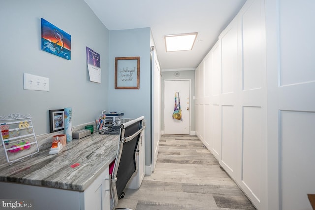 corridor with light hardwood / wood-style flooring