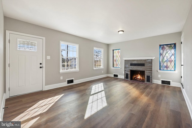 unfurnished living room featuring dark hardwood / wood-style flooring