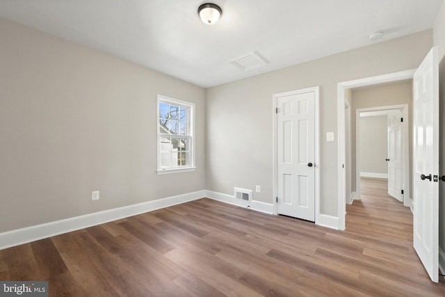 unfurnished bedroom with hardwood / wood-style floors