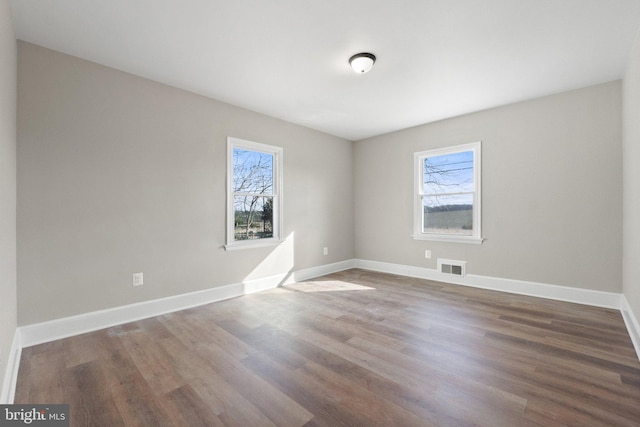 spare room featuring dark hardwood / wood-style flooring