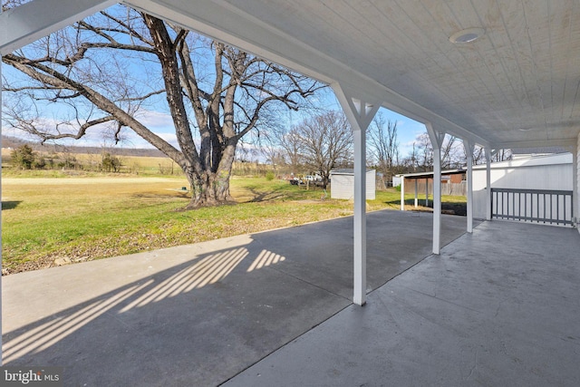 view of patio with a shed and a carport