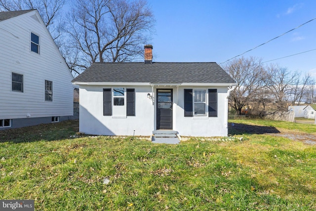 bungalow-style home with a front lawn