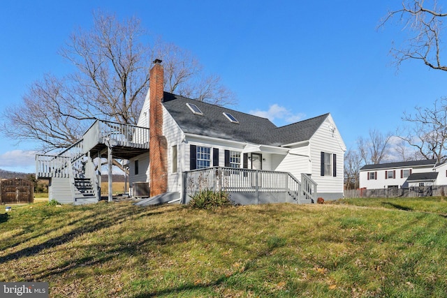 view of side of property featuring a lawn and a deck