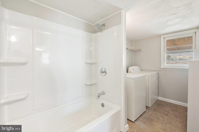 bathroom featuring tile patterned flooring, independent washer and dryer, a textured ceiling, and bathing tub / shower combination