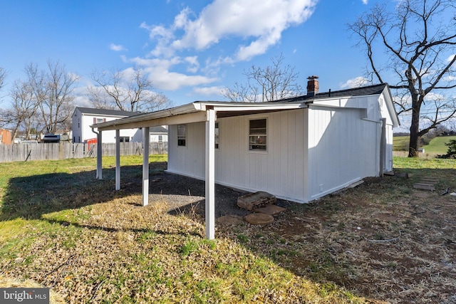 back of property featuring a yard