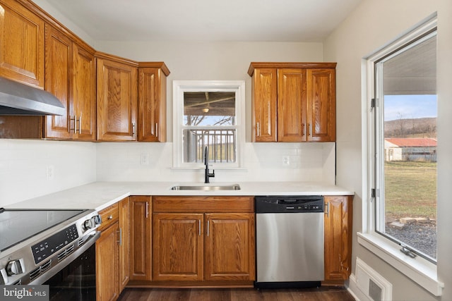 kitchen featuring backsplash, sink, dark wood-type flooring, and appliances with stainless steel finishes