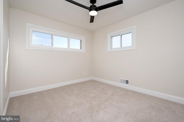 unfurnished room featuring ceiling fan and light colored carpet