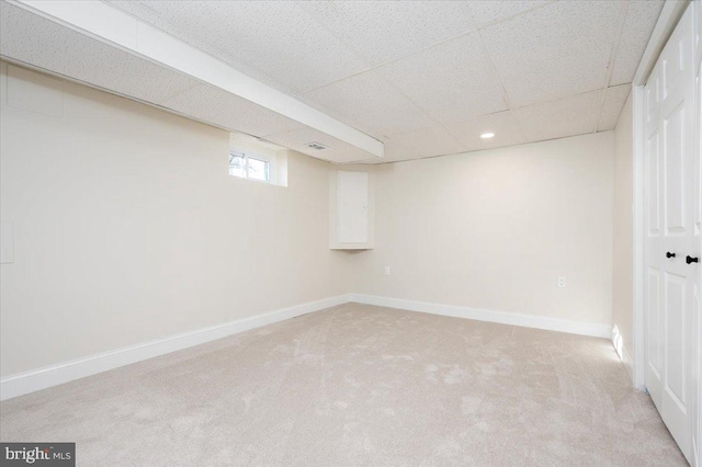 basement featuring light colored carpet