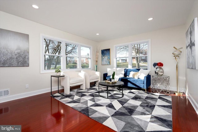 sitting room featuring dark hardwood / wood-style floors and a wealth of natural light