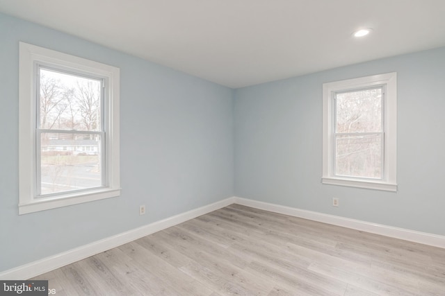 spare room with light hardwood / wood-style flooring