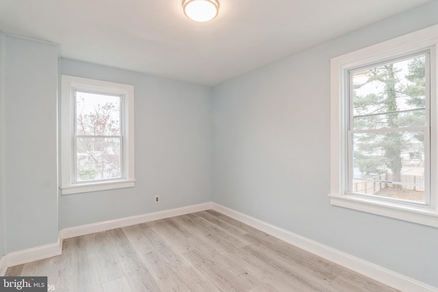 spare room with light hardwood / wood-style flooring