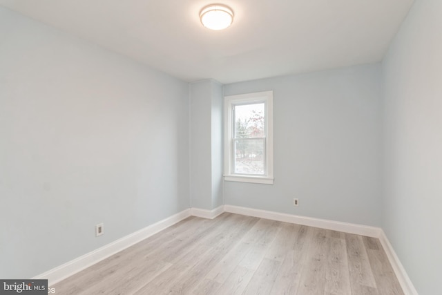 empty room with light hardwood / wood-style flooring