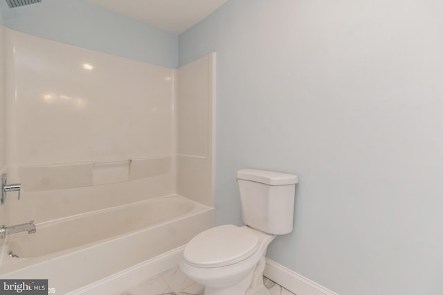 bathroom featuring shower / bathing tub combination and toilet