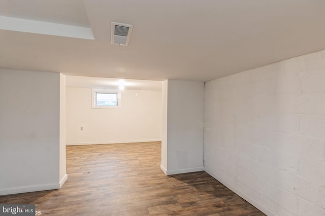 basement with hardwood / wood-style floors