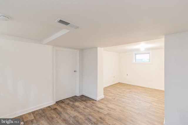 basement with light hardwood / wood-style flooring