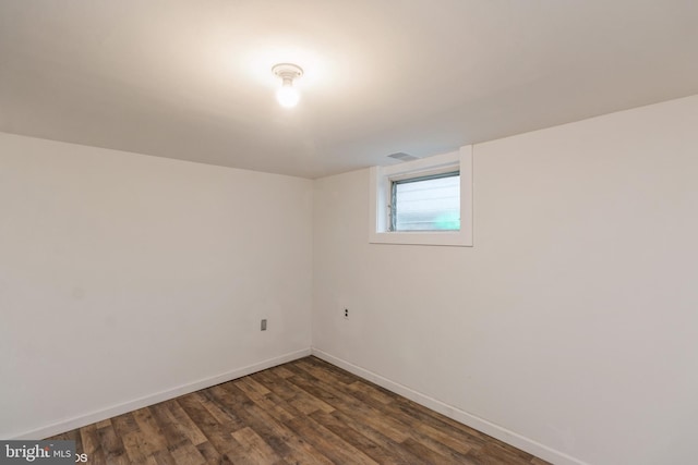 basement featuring dark hardwood / wood-style flooring