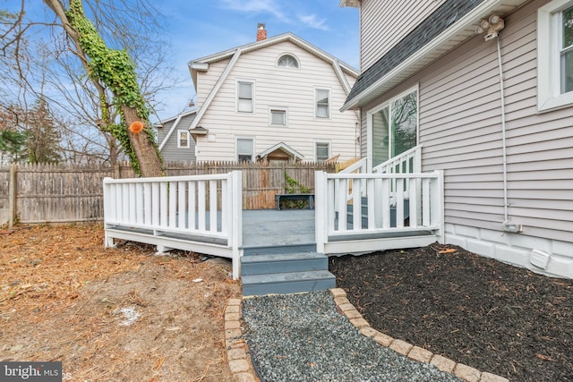 back of property featuring a wooden deck