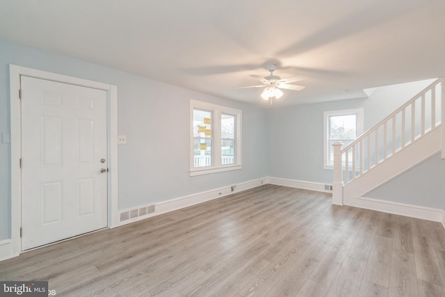 interior space with ceiling fan, a wealth of natural light, and light hardwood / wood-style flooring