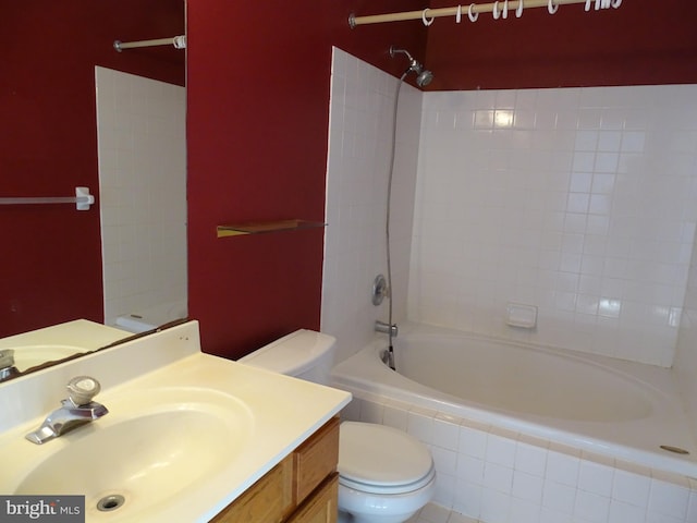 full bathroom with tiled shower / bath combo, toilet, and vanity