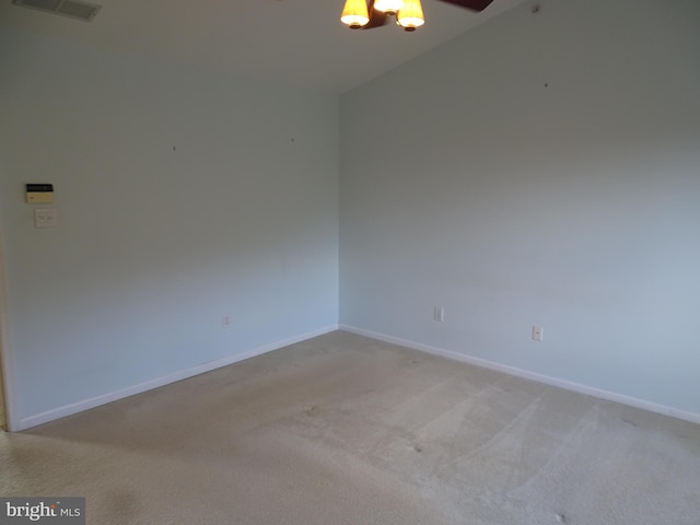 carpeted empty room featuring ceiling fan