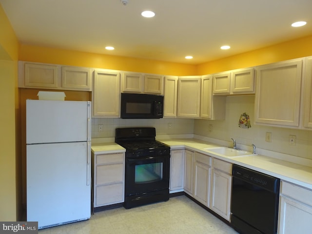 kitchen featuring black appliances, decorative backsplash, and sink