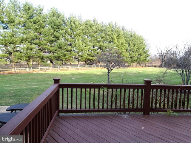 wooden deck with a lawn