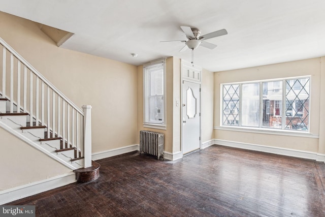 entrance foyer with ceiling fan, radiator heating unit, and dark wood-type flooring