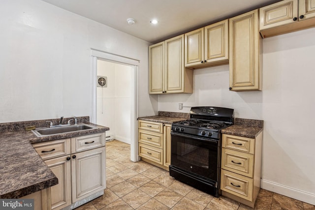 kitchen featuring black gas range oven and sink