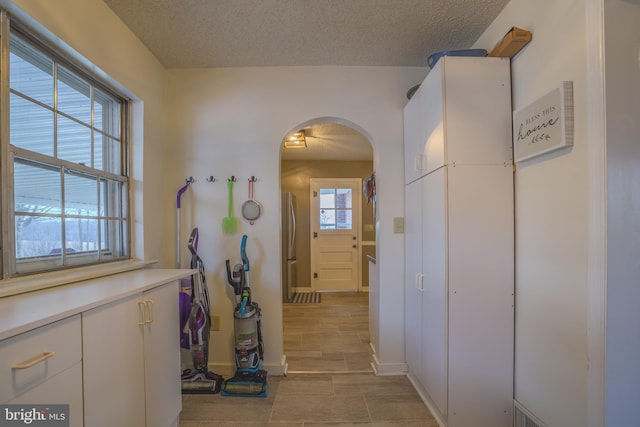 hallway featuring a textured ceiling