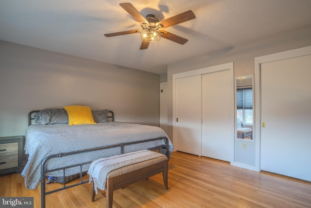 bedroom featuring ceiling fan, light hardwood / wood-style floors, and a textured ceiling