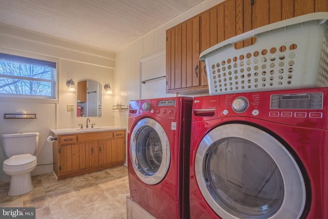 washroom with washing machine and dryer and sink