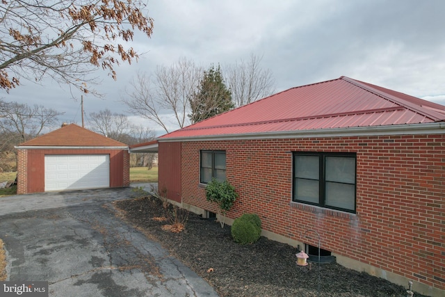 view of home's exterior with an outdoor structure and a garage