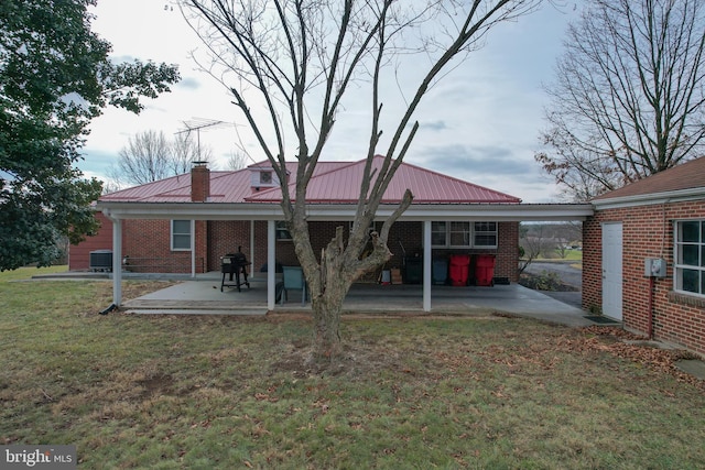 rear view of house featuring cooling unit, a patio area, and a yard