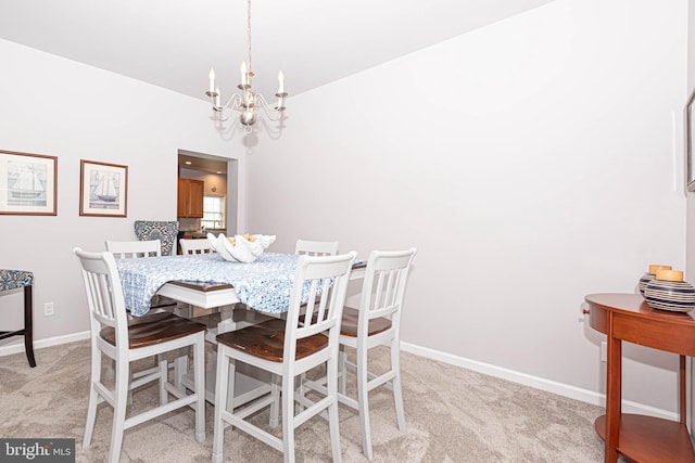 dining area with a notable chandelier, light colored carpet, and vaulted ceiling