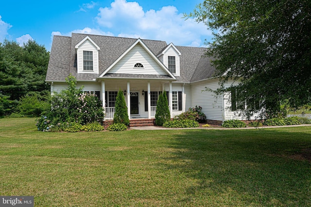 cape cod house featuring covered porch and a front lawn