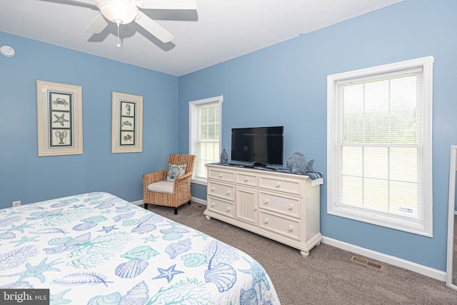 bedroom featuring ceiling fan and dark colored carpet