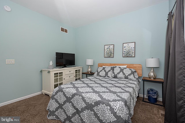 bedroom featuring dark carpet