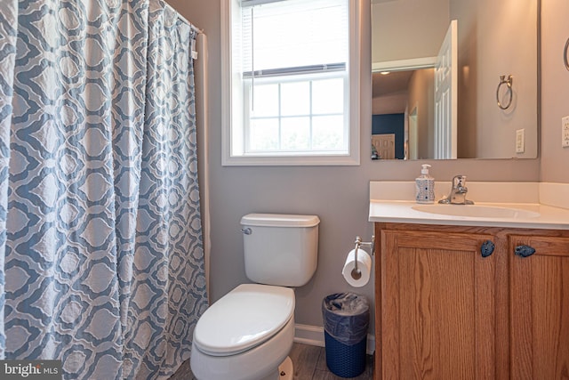 bathroom featuring a shower with shower curtain, hardwood / wood-style floors, vanity, and toilet