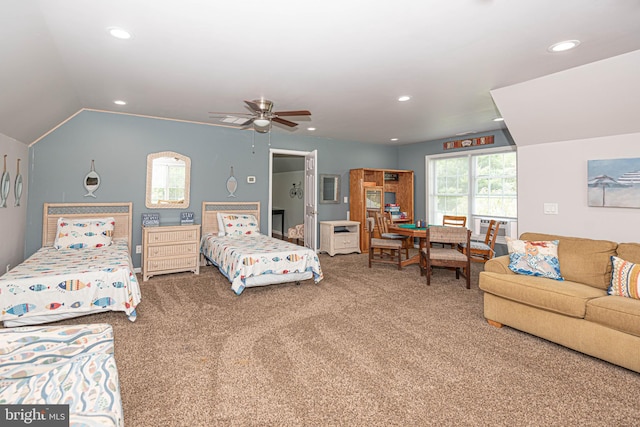 carpeted bedroom with ceiling fan and vaulted ceiling