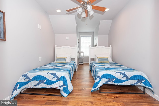 bedroom featuring hardwood / wood-style flooring, ceiling fan, and lofted ceiling