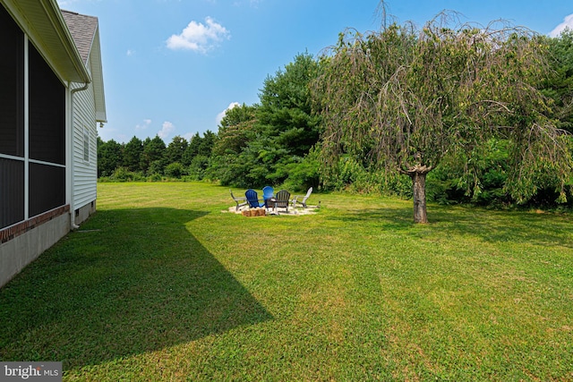 view of yard with a fire pit