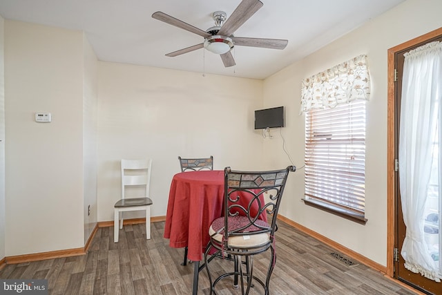 dining space featuring hardwood / wood-style floors and ceiling fan