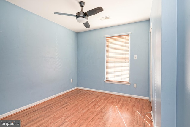 empty room featuring ceiling fan, light hardwood / wood-style floors, and a wealth of natural light