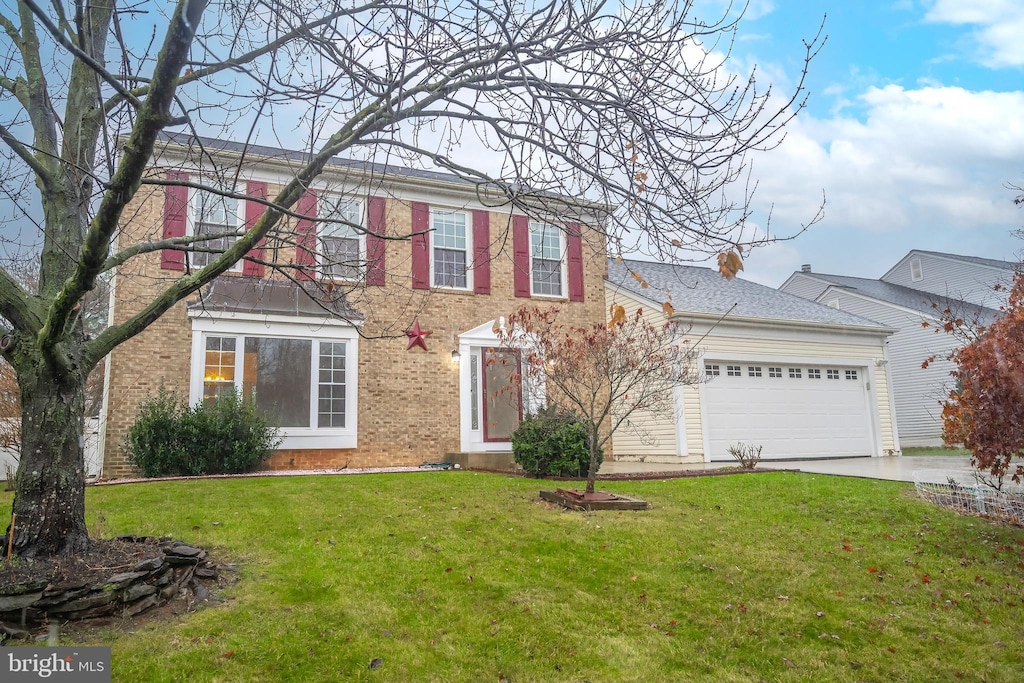 view of front of property with a front yard and a garage