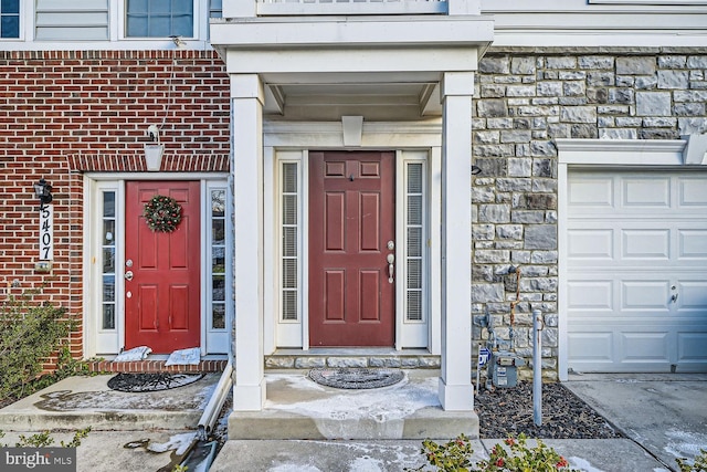 doorway to property with a garage